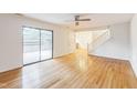 Open concept living area with hardwood floors, light walls, and sliding glass doors to backyard at 127 Finley Forest Dr, Chapel Hill, NC 27517