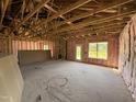 Bright living room under construction with exposed beams, ready for customization at 136 Tuskeegee Dr, Smithfield, NC 27577
