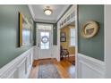Inviting foyer featuring hardwood floors and detailed wainscoting at 137 Cofield Cir, Durham, NC 27707