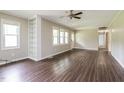 Inviting living room featuring wood-look flooring and a built in bookcase at 1405 Kenbrook Dr, Garner, NC 27529
