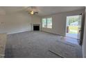 Spacious living room with a fireplace, ceiling fan and plenty of natural light at 152 Tulipfield Way, Benson, NC 27504
