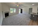 Spacious living room with a fireplace, ceiling fan and plenty of natural light at 152 Tulipfield Way, Benson, NC 27504