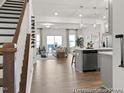 Open-concept living space with hardwood floors, seamlessly connecting the living room and kitchen area at 157 N District Ave # 291, Clayton, NC 27527