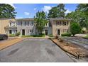 Exterior shot of townhomes featuring neat landscaping, ample parking, and well-maintained facades at 1602 Township Cir, Raleigh, NC 27609