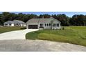 Inviting one-story home with a well-manicured lawn and a convenient driveway leading to the garage at 171 Tulipfield Way, Benson, NC 27504
