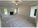 Spacious living room with a cozy fireplace, vaulted ceilings, and ample natural light from the windows at 171 Tulipfield Way, Benson, NC 27504