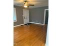 Spacious living room featuring hardwood floors, neutral paint, and a ceiling fan at 200 S Pettigrew St, Raleigh, NC 27610