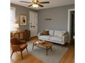 Cozy living room with neutral walls, a light sofa, wood furniture, and ample natural light at 200 S Pettigrew St, Raleigh, NC 27610