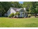 Well-maintained home showcasing lush landscaping and a side entrance at 2213 Stephanie Ln, Clayton, NC 27520