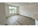 Bright living room with hardwood floors and a large window offering ample natural light at 2411 Whitewing Ln, Wendell, NC 27591