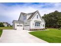 Beautiful two-story home with an attached three car garage and expansive paved driveway at 2617 Packhouse Rd, Zebulon, NC 27597