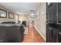 Inviting living room featuring beautiful wood floors and ample natural light at 313 Weeping Willow Dr, Durham, NC 27704