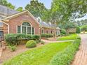 Charming brick home featuring a landscaped front yard and a welcoming brick pathway to the front door at 3347 Ridgecrest Ct, Raleigh, NC 27607