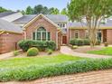 Charming brick home featuring a landscaped front yard with a welcoming brick pathway to the front door at 3347 Ridgecrest Ct, Raleigh, NC 27607
