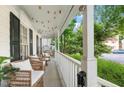 Inviting front porch with charming decor, comfortable seating, creating a relaxing outdoor space at 3541 E Jameson Rd, Raleigh, NC 27604