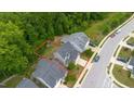 Aerial view showcases the property's boundaries, placement on the lot, and surrounding wooded area at 4001 Bostwyck Dr, Fuquay Varina, NC 27526