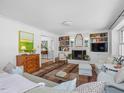 Cozy living room featuring a brick fireplace, built-in bookshelves, and comfortable seating at 4112 Rowan St, Raleigh, NC 27609