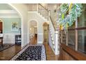 Inviting foyer features hardwood floors, staircase, decorative wreath, and views into other rooms at 5112 Highbury Grove Ln, Fuquay Varina, NC 27526