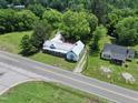 Aerial view of the property showcasing the home, lush greenery, and nearby road access at 522 Providence Rd, Roxboro, NC 27573