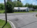Quaint home with a covered porch, classic design, and picturesque street view at 522 Providence Rd, Roxboro, NC 27573