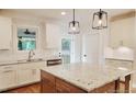 Bright kitchen with granite countertops, stainless steel appliances, and pendant lighting at 5491 Silk Hope Gum Springs Rd, Siler City, NC 27344