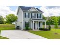 Inviting two-story home with a covered front porch, offering a welcoming entrance and curb appeal at 60 Waterwheel Dr, Selma, NC 27576