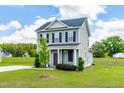 Well-maintained two-story home with a neatly landscaped front yard, showcasing pride of ownership at 60 Waterwheel Dr, Selma, NC 27576