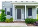Charming front porch with a welcoming sign and seating, perfect for relaxing and enjoying the outdoors at 60 Waterwheel Dr, Selma, NC 27576