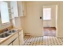 Galley kitchen with dual stainless sink, wood counters, and vintage cabinetry at 628 Massey Ave, Durham, NC 27701