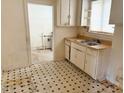 Galley kitchen with dual stainless sink, wood counters, and vintage cabinetry at 628 Massey Ave, Durham, NC 27701