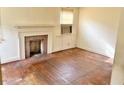Living room featuring a brick fireplace, hardwood floors, and natural light at 628 Massey Ave, Durham, NC 27701