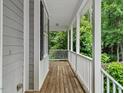 A cozy front porch with white railings offers a relaxing outdoor space at 635 Buckroe Dr, Sanford, NC 27330