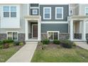 Inviting front entrance with stone accents, a covered porch, and well-maintained landscaping at 6618 Perry Creek Rd, Raleigh, NC 27616