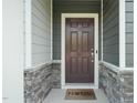 Charming front door with stone accents and covered porch at 6618 Perry Creek Rd, Raleigh, NC 27616