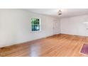 Sunlit living room featuring hardwood floors and neutral walls, ideal for versatile decorating at 905 S 1St St, Smithfield, NC 27577