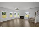 Spacious living room with hardwood floors, a fireplace, and plenty of natural light from the large windows at 91 Merle Way Way, Wendell, NC 27591