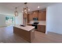 Gourmet kitchen features an island, modern appliances, and stylish pendant lighting at 1002 Regalia Rd # 2, Durham, NC 27713
