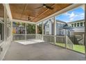 Spacious screened porch featuring a wood ceiling and views of the landscaped backyard at 1029 Whitehall Cir, Durham, NC 27713