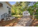 Fenced backyard with a detached garage, offering privacy and secure parking at 1109 N Pinkston St. St, Henderson, NC 27536