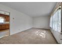 Spacious living room with large windows and a doorway leading to the kitchen at 1109 N Pinkston St. St, Henderson, NC 27536