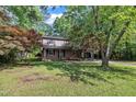 Traditional-style home with brick facade, a covered front porch and lush front yard at 1115 Chestnut Dr, Smithfield, NC 27577