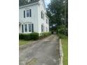 Long driveway leading to a detached two-car garage, offering ample parking space and privacy at 112 E Sycamore St, Zebulon, NC 27597