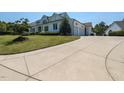 Spacious driveway leading to an attached two-car garage and complementing the home's exterior design at 115 Founders Ridge Dr, Chapel Hill, NC 27517