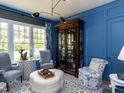 Comfortable sitting room with blue walls, a large cabinet, and plush seating, perfect for relaxation at 115 Founders Ridge Dr, Chapel Hill, NC 27517