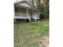 Quaint home with a covered front porch and potential for a lovely front yard at 116 Dunstan Ave, Durham, NC 27707