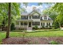 Traditional home with a cozy front porch and well-manicured lawn at 118 Cavendish Ct, Hillsborough, NC 27278