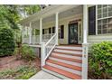 Inviting front porch with classic columns and freshly painted steps leading to the entrance at 118 Cavendish Ct, Hillsborough, NC 27278