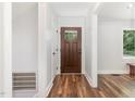 Bright and airy hallway features wood floors, fresh paint, and an entryway to welcome guests into the home at 1209 Lanark Ct, Cary, NC 27511