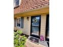 Close-up of the front door with a wreath and potted flowers at 141 Jones Franklin Rd # G, Raleigh, NC 27606