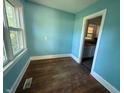 Sunny dining area with hardwood floors and blue walls at 1525 Hargrove St, Rocky Mount, NC 27801
